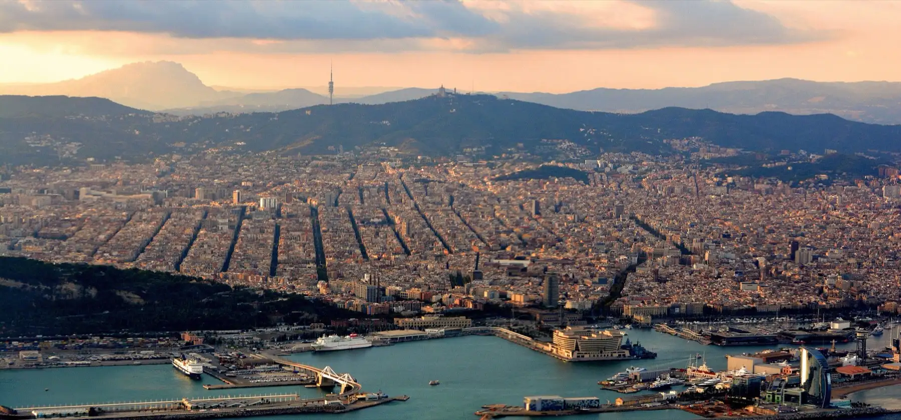With part of the Port of Barcelona in the foreground and Montserrat Mountain at top left