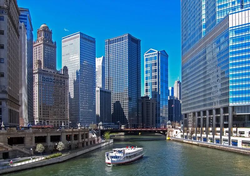 A Chicago River tour boat passes in front of Trump Tower