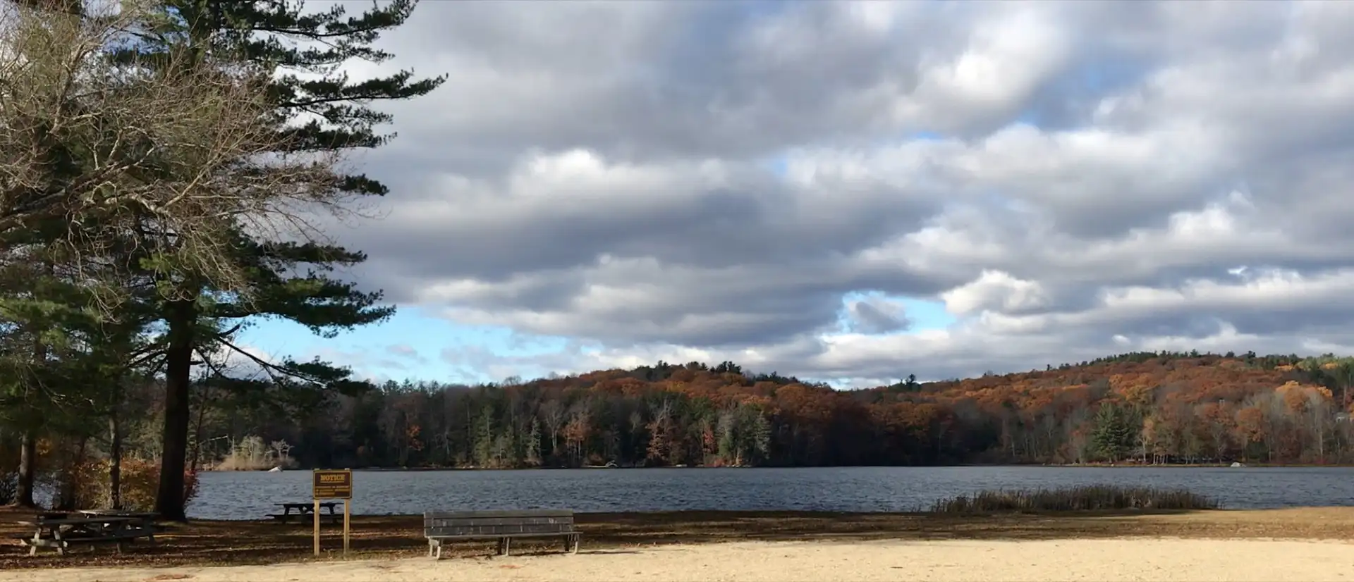 Paugnut State Forest's hills in autumn viewed from the north-east shore of Burr Pond.