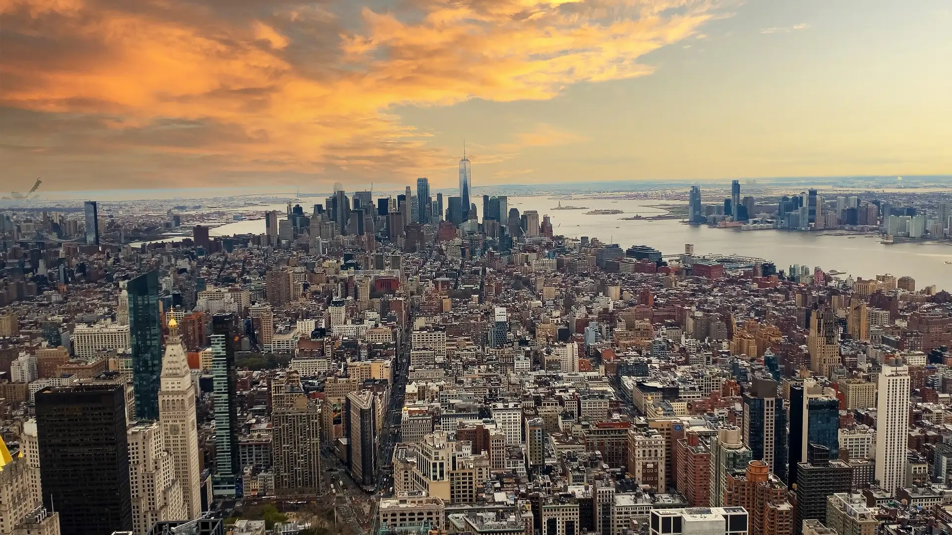 Lower Manhattan skyline across the harbor at dusk